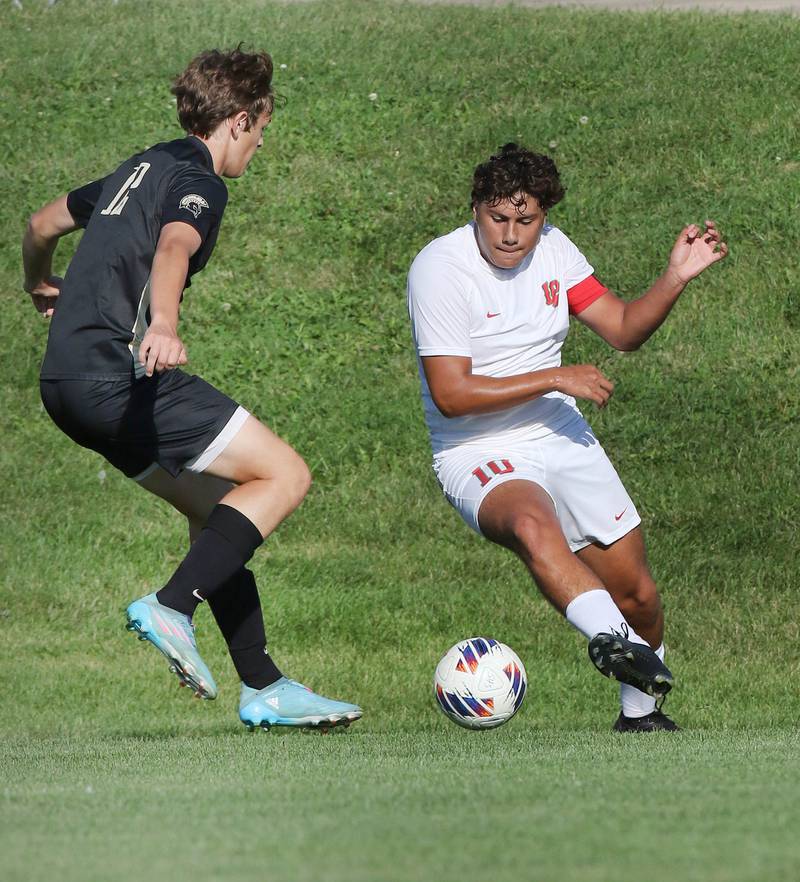 La Salle-Peru's Giovanni Garcia tries to get the ball by Sycamore's Carter England during their game Wednesday, Sept. 7, 2022, at Sycamore High School.