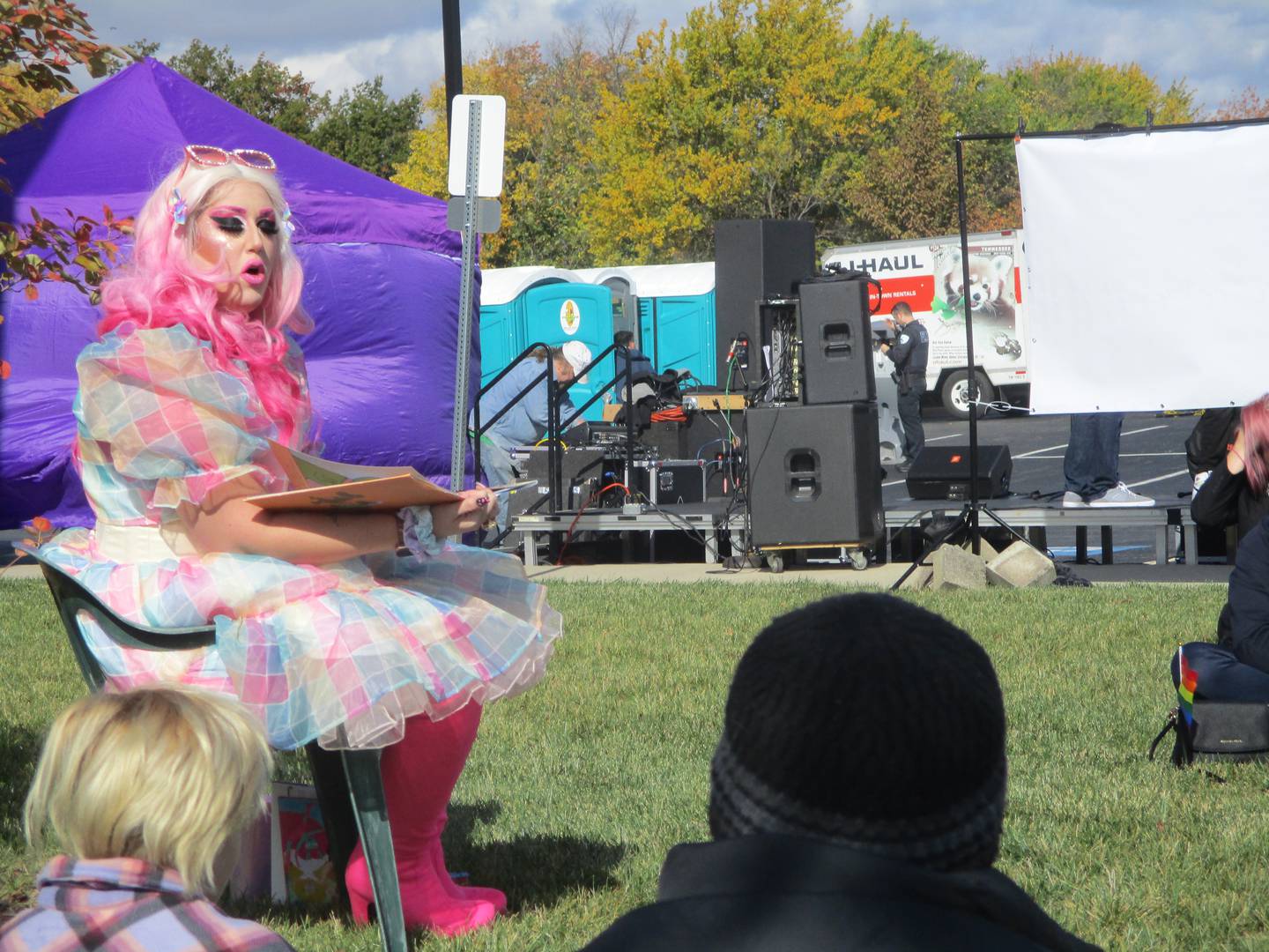 Summer Kornfeind, in her drag costume as Cindi Forest, reads stories to children and their parents at Plainfield Pride Fest. Oct. 16, 2022.