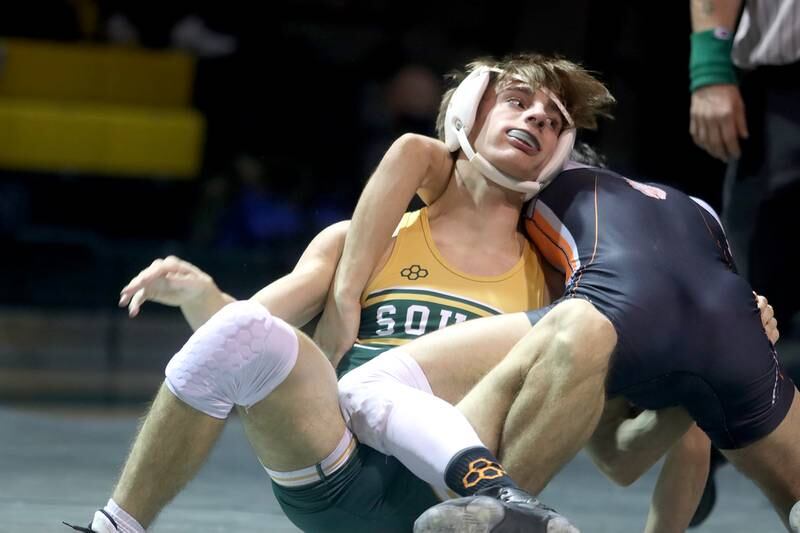 Crystal Lake South’s Austin Laurie battles McHenry’s Ryan Nagel  in a 132-pound match during varsity wrestling at Crystal Lake Thursday night.