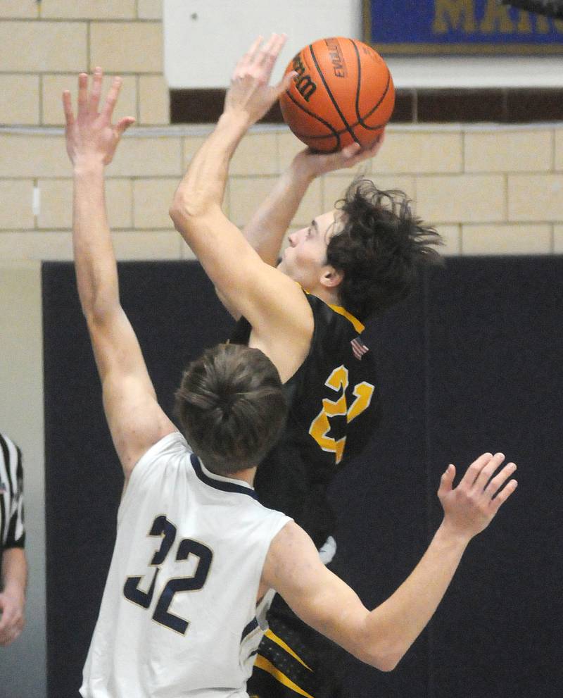 Putnam County's Orlando Harris shoots past Marquette's Charlie Mullen at Bader Gymnasium on Friday, Feb. 3, 2023.