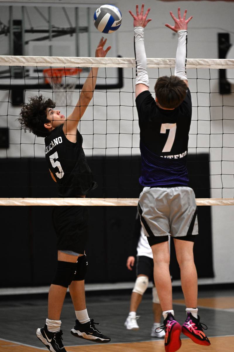 Kankakee Trinty Academy's Gio Feliciano sets the ball over the net as Manteno's Elijah Kraft blocks on Thursday, May 1, 2025.