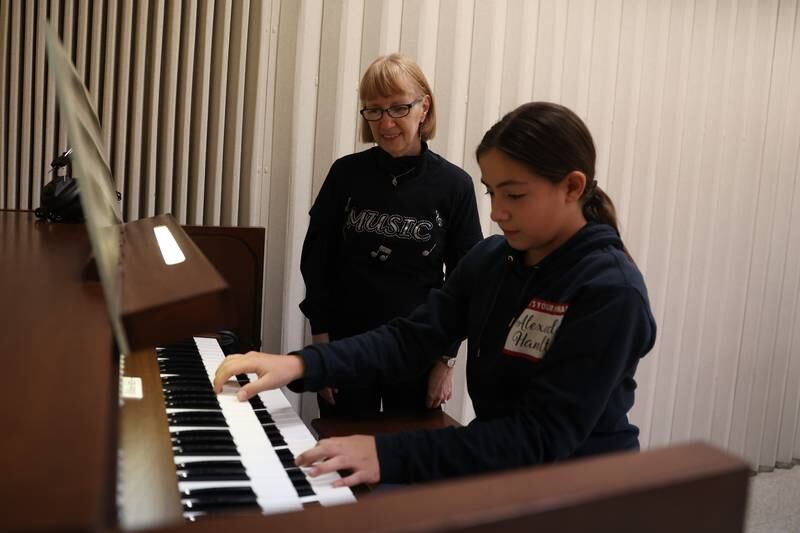 Sarah Randolph, a retired Lockport district music teacher, teaches Samantha Del Rio, 11, on the organ donated to her at the First Presbyterian Church in Joliet.