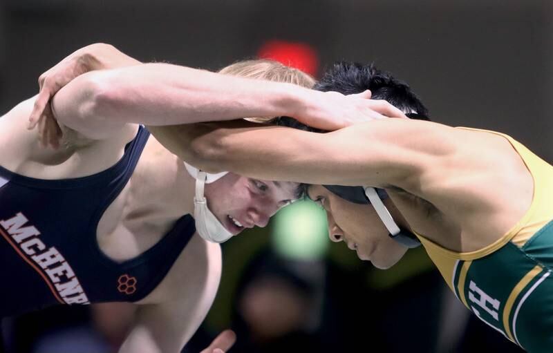 Crystal Lake South’s Alex Flores, right, battles McHenry’s Justin Karcz  in a 138-pound match during varsity wrestling at Crystal Lake Thursday night.