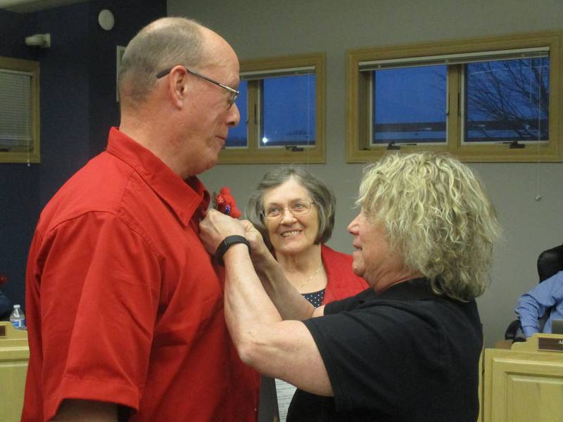 Yorkville American Legion Post 489 Auxiliary President Diane Dillow pins a poppy on Yorkville Mayor John Purcell, while Poppy Days Chairman Joanne Leibold looks on. The annual Poppy Days collection for veterans is May 9 to 15. (Mark Foster -- mfoster@shawmedia.com)