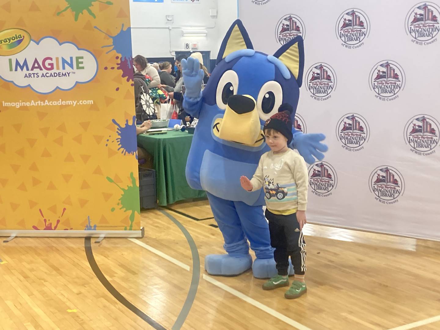 Walter Collier poses with Bluey during a meet and greet at the Will County Kids Fair at Troy Middle School in Plainfield on Monday, Feb. 17, 2025.