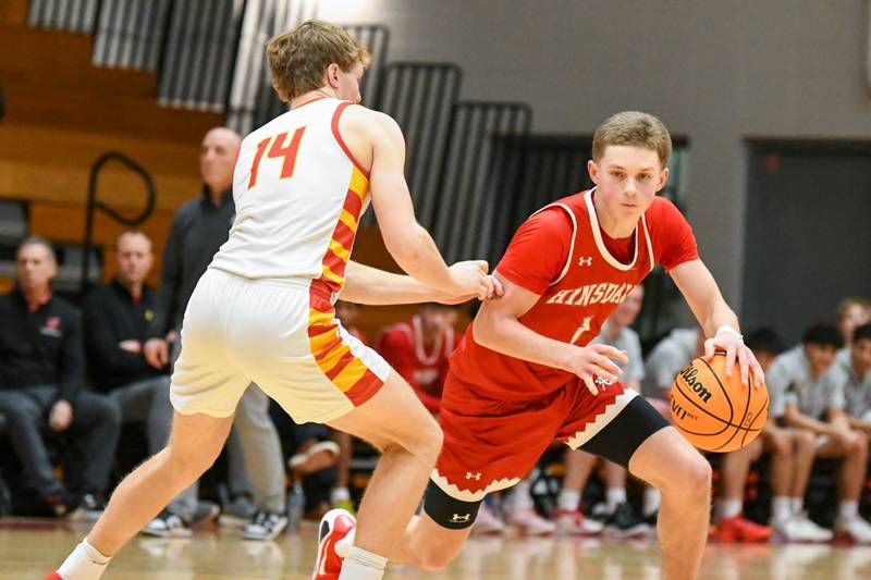 Hinsdale Central's Kristopher Dowell (1) tries to get around Batavia's Brett Berggren (14) during the game on Saturday Jan. 24, 2026, held at Batavia High School.
