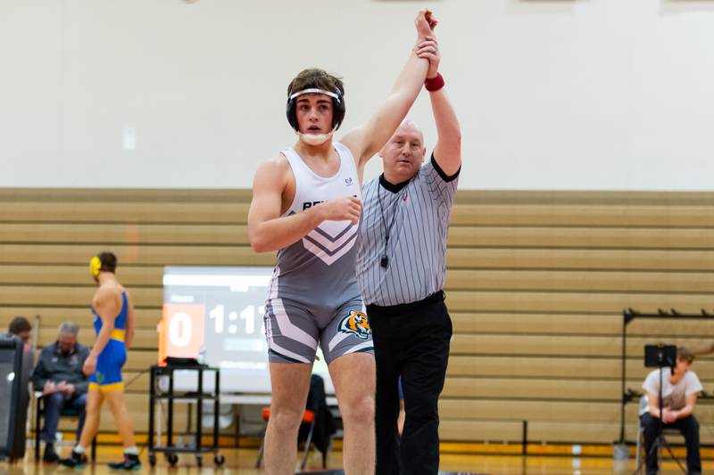 Joseph Nino of Plainfield East defeats Joliet Central's Brendan Hearn in the 165-pound match at Plainfield East on Dec. 12, 2024.