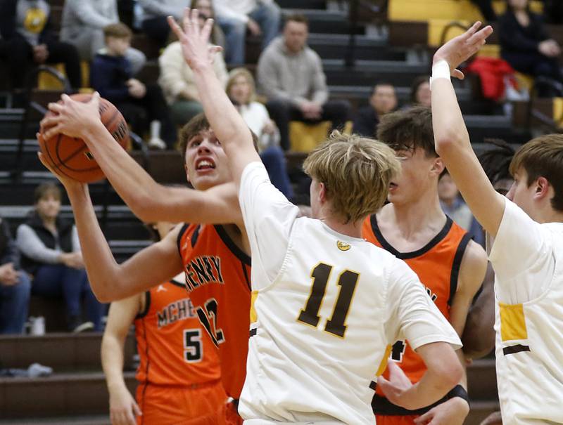 McHenry's Caleb Jett drives to the basket against \Jacobs' Max Fessler during a Fox Valley Conference boys basketball game on Wednesday, Nov. 29, 2023, at Jacobs High School in Algonquin.