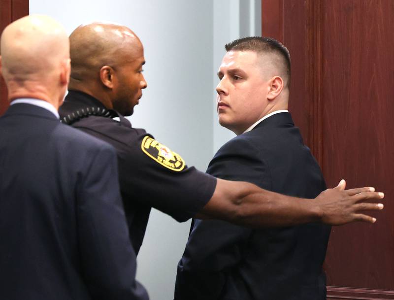 Former police officer James Corralejo (right) looks back at his family as he is taken into custody Thursday, July 17, 2025, at the DeKalb County Courthouse in Sycamore. Corralejo was sentenced to four years in prison for a Class 2 felony count of driving under the influence of alcohol causing death for a 2023 crash that killed DeKalb woman Graciela Reza Contreras.