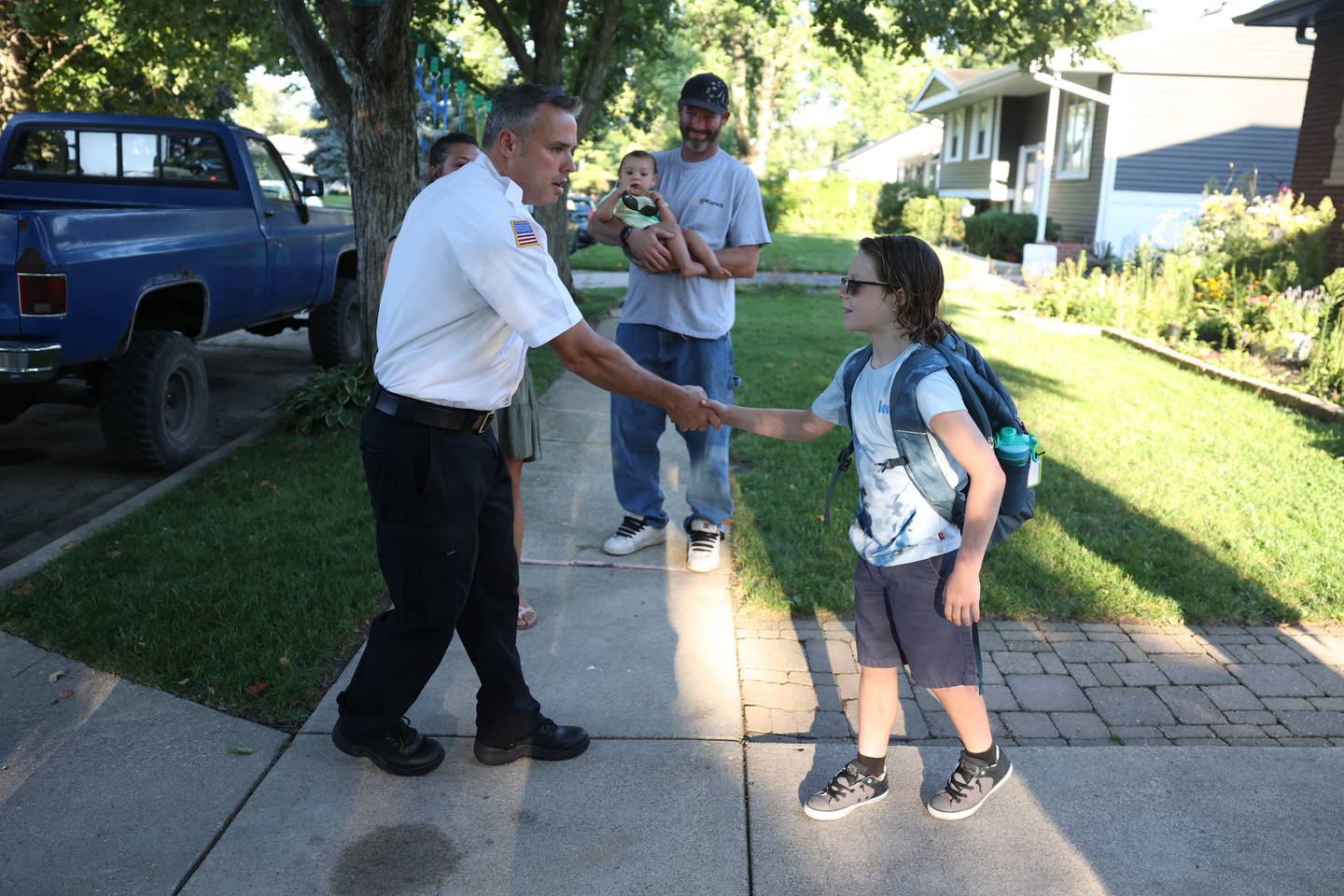 Fire battalion chief John Koch greets William Zaffino. William won a raffle to get a ride in a fire truck to his first day of school at Eisenhower Academy in Joliet. Wednesday, Aug. 17, 2022, in Joliet.