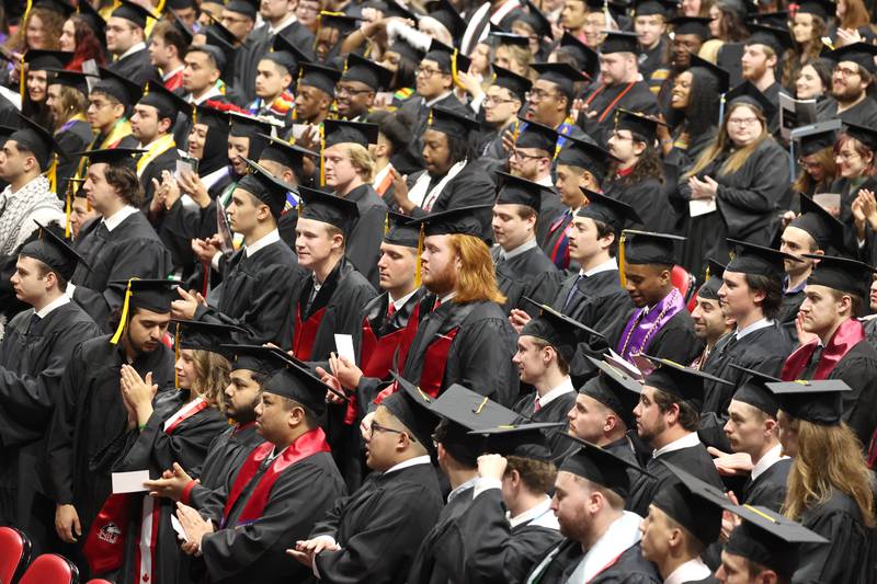 Northern Illinois University candidates for graduation listen to speakers during the first of two undergraduate commencement ceremonies Saturday, May 11, 2024, in the Convocation Center at NIU in DeKalb.