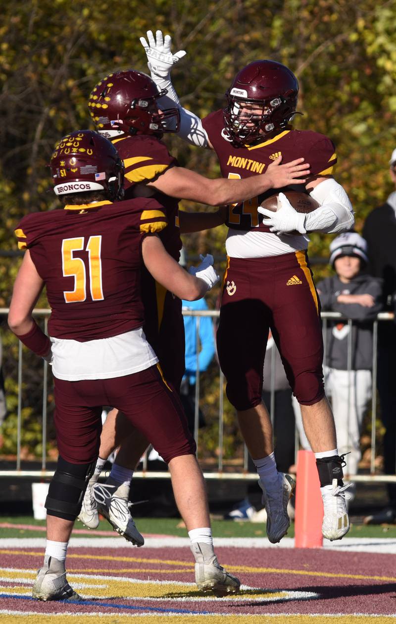 Joe Lewnard/jlewnard@dailyherald.com
Montini's George Asay , right, celebrates his touchdown with teammates Alex Marre and Dario Mattiuz (51) during the Class 3A semifinal game against Byron Saturday.