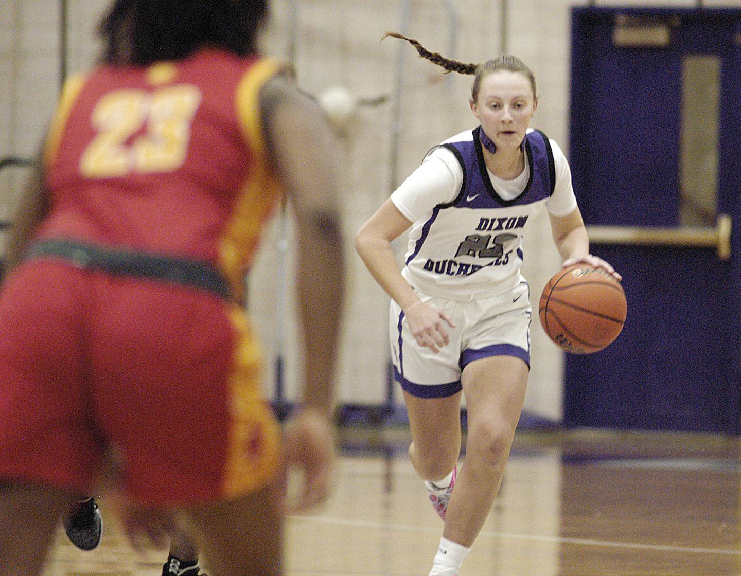 Dixon's Katie Drew brings the ball downcourt against Rock Island  Friday, December 22, 2023 during a game at Dixon High School. (Brian Hurley - Shaw Local News Network)