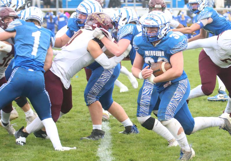 Princeton's Common Green carries the football against Montini Catholic during the Class 3A quarterfinal game on Saturday, Nov. 16, 2024 at Bryant Field in Princeton.