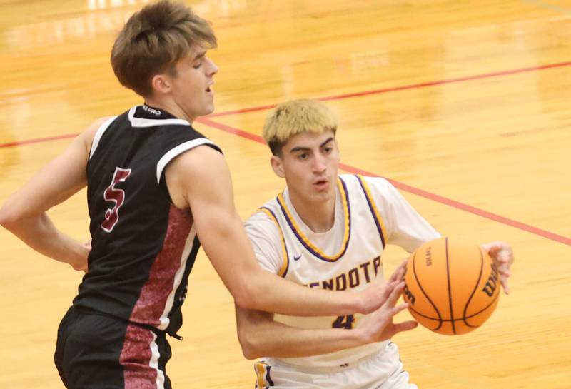 Mendota's Johan Cortez looks to pass the ball away from Illinois Valley Centra's Grady Read during the Colmone Classic on Friday, Dec. 12, 2025 at Hall High School.