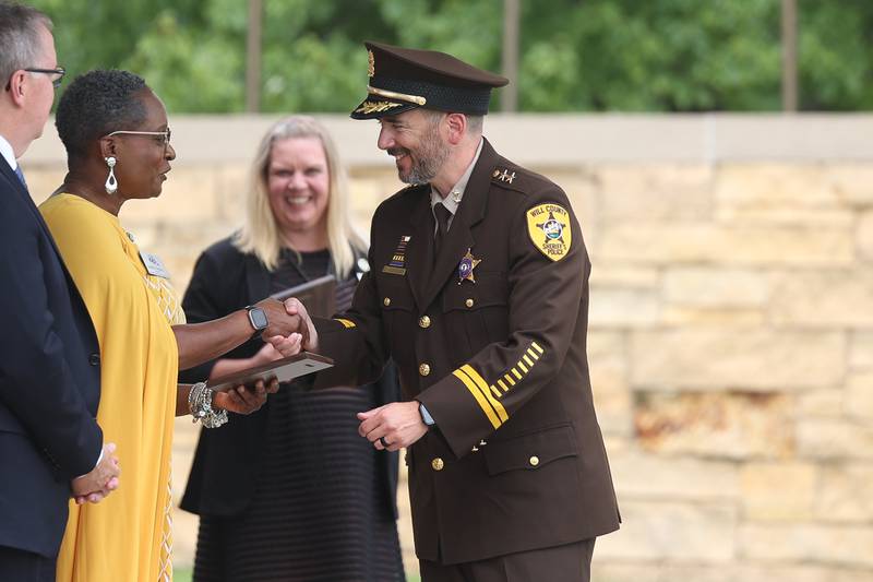 Deputy Chief Dan Jungles excepts a plaque of recognition on behalf of the Will County Sheriff’s department at the National Cemetery Administration 50th Anniversary ceremony at the Abraham Lincoln National Cemetery in Elwood on Saturday, July 29.
