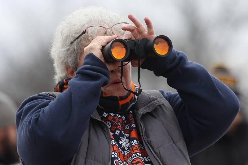 Mary Lou Carr, of Minooka, uses her binoculars to spot an eagle along the Des Plaines River at the Four Rivers Environmental Education Center’s annual Eagle Watch program in Channahon.