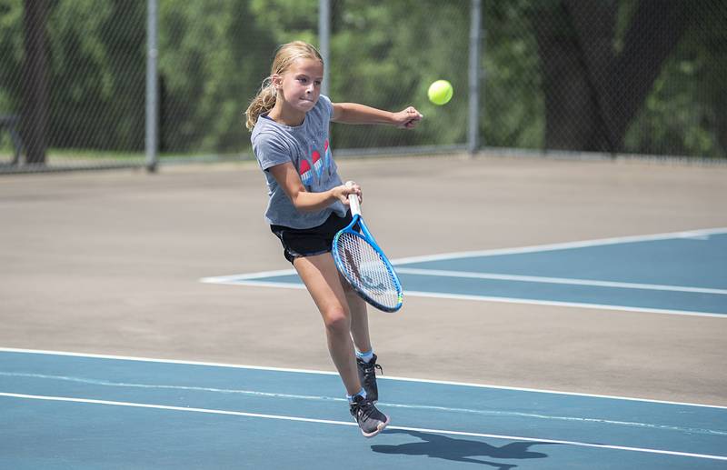 Anna Partington returns a shot while playing in the 11 and under girls singles at the Emma Hubbs tennis classic Thursday, July 26, 2022.