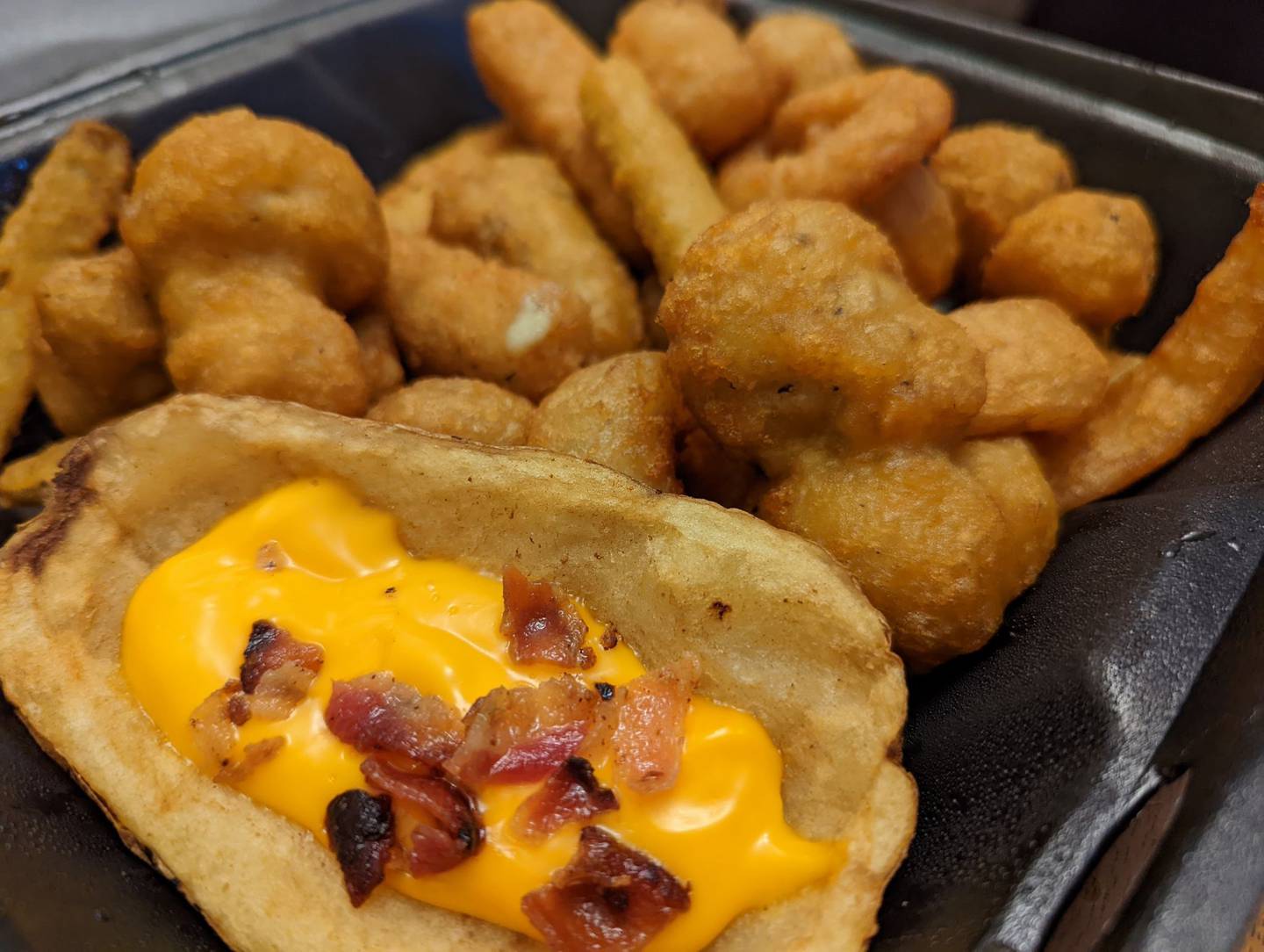 The appetizer combo platter for $10 at Happy Place Cafe in Shorewood includes cheese sticks, onion rings, potato skins, breaded mushrooms, zucchini and cauliflower.