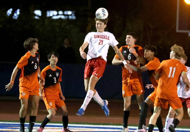 Hinsdale Central's Kostas Zamalaitis heads the ball among a group of Hersey players Friday, Nov. 8, 2024, during their Class 3A state semifinal game at Hoffman Estates High School.