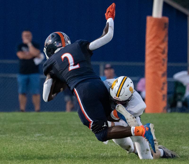Neuqua Valley's Peyton Kuhl (9) tackles Oswego’s Nicholas Scott (2) during a football game at Oswego High School on Friday, Aug 26, 2022.