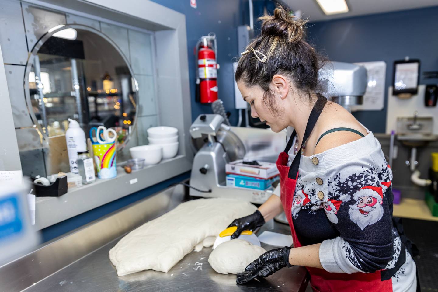 Nicola's Heavenly Cucina owner, Nicole Pavlinic, separates a sourdough batch into individual loaves at her Lockport bakery on Dec. 18, 2024.