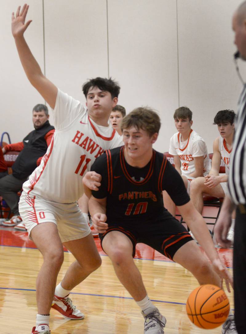 Erie-Prophetstown's Evan Steimle (10) drives the baseline as Oregon's Nole Campos (11) defends during Monday, Feb. 24, 2025 2A regional action at the Blackhawk Center in Oregon.