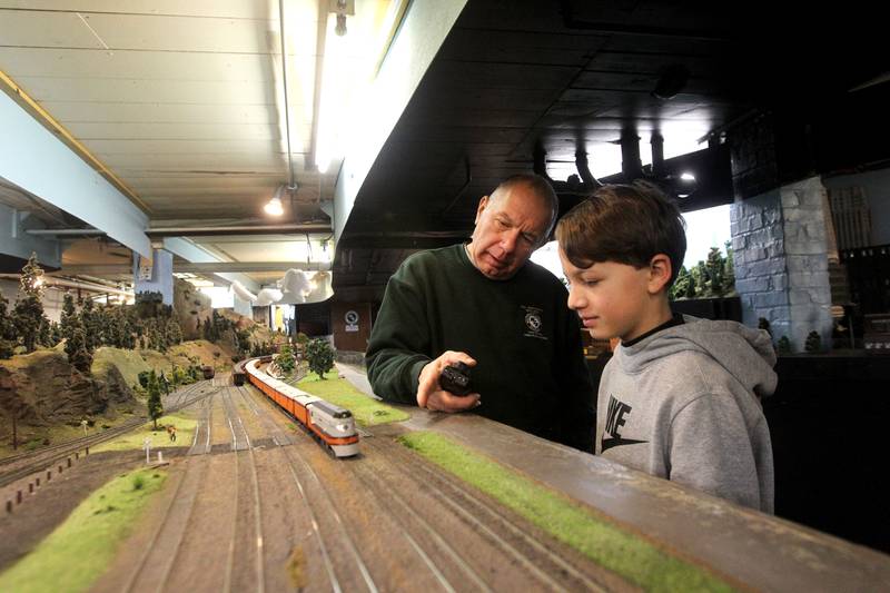 Frank Blacker talks with Alex Keith, 11, both of Wauconda as he points out the details of his Milwaukee Hiawatha passenger train that was running on the tracks at the Lake County Model Railroad Club in Wauconda. The club is celebrating their 50th anniversary.