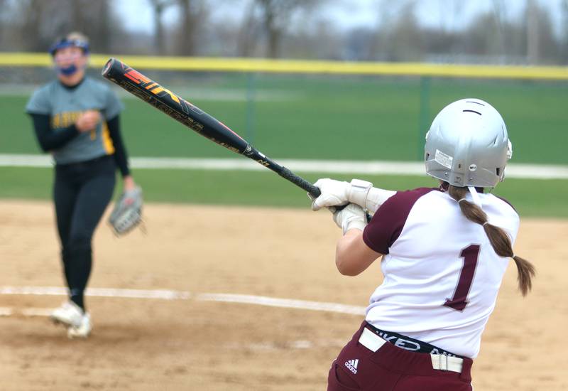 Marengo’s Gabby Christopher watches the flight of a home run against Harvard in varsity softball at Marengo Thursday.