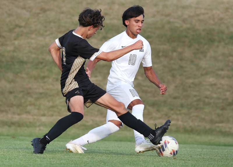 Sycamore's Noah Daykin (left) tries to steal the ball from Kaneland's Jovani Ruiz during their game Wednesday, Sept. 18, 2024, at Sycamore High School.