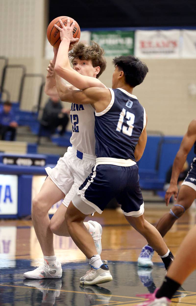 Brian Hill/bhill@dailyherald.com
Geneva’s Cole Engebretson (12) is fouled by Downers Grove South’s Ryan Enger (13) on his way to the hoop Friday November 24, 2023 in Geneva.