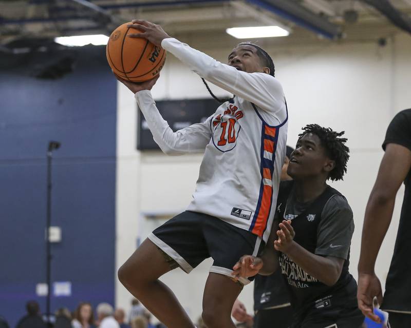 Oswego's Mj Johnson (10) puts in an acrobatic shot  in their Riverside-Brookfield Shootout basketball game.  June 20, 2025 in Riverside.