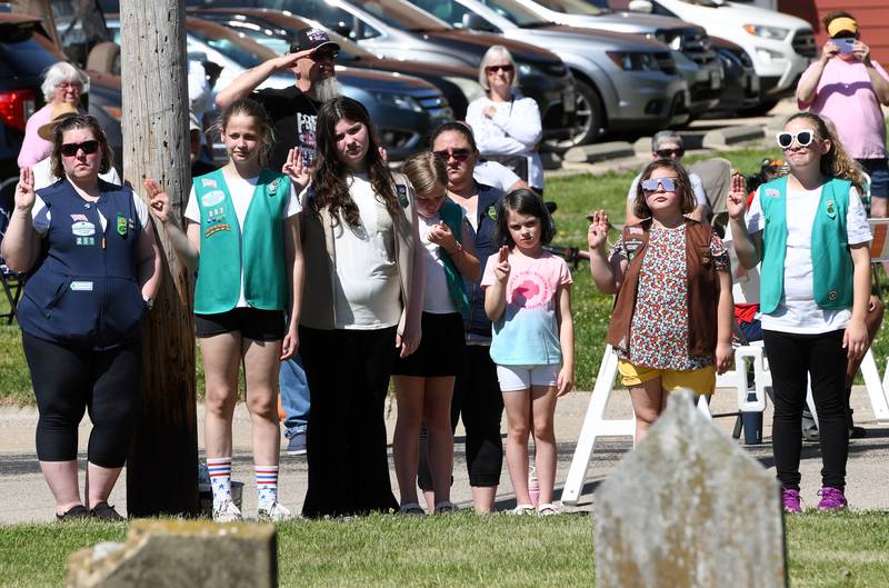 Girl Scouts and their leaders stand at attention during Oregon's Memorial Day Service on Monday, May 25, 2026 at the Riverside Cemetery.