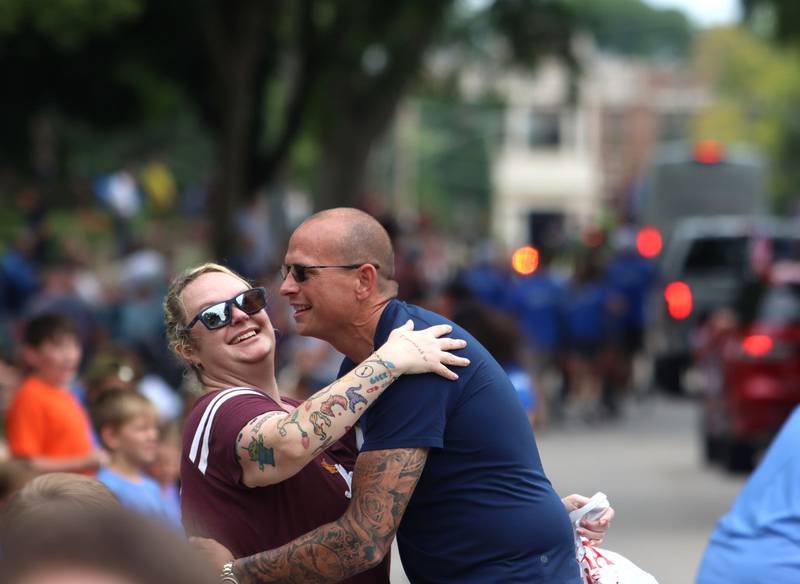 Mayor Wayne Jett Greets Nicole Djus of McHenry along  the Fiesta Days Parade on Main Street in McHenry on Sunday, July 20, 2025. Djus thanked Jett for the assistance that he and the city offered after Djus experienced a house fire in 2023.