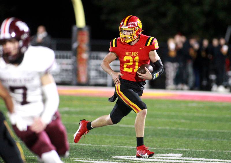 Batavia quarterback Ryan Boe keeps the ball during a Class 7A round 1 playoff game against Brother Rice in Batavia on Friday, Oct. 27, 2023.