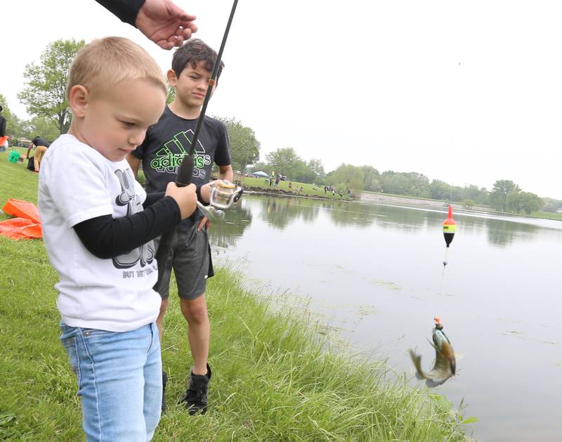 Matt Flaherty of Ladd, reels in a sunfish during the twenty-third annual Kids Fishing Expo on Saturday, May 13, 2023 at Baker Lake in Peru.