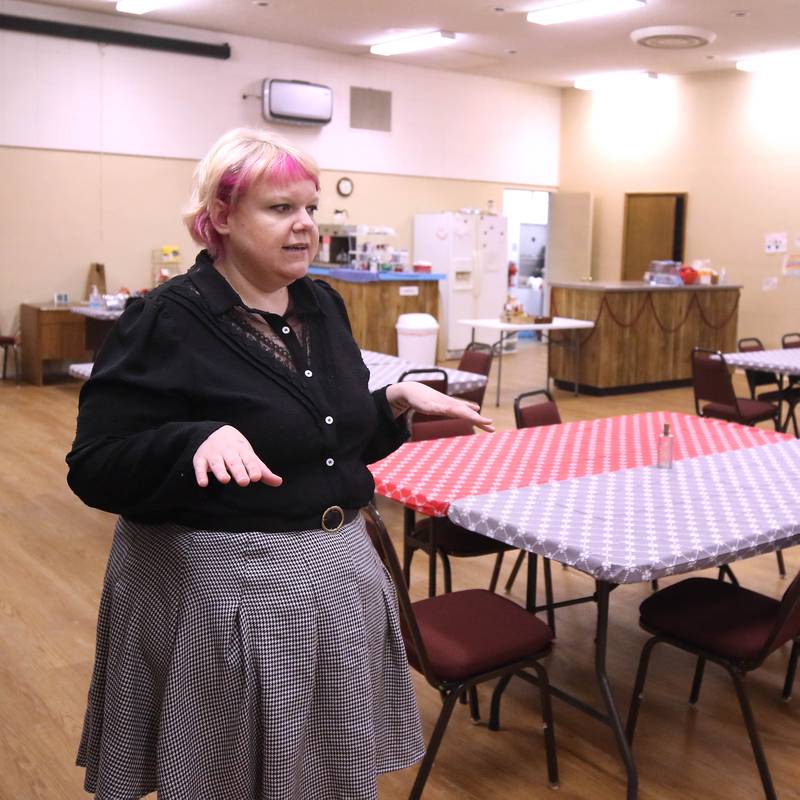 Ash Rootes, director of the overnight warming center at the Unitarian Universalist Fellowship of DeKalb, talks Thursday, Jan. 23, 2025, at the church, about the main eating and sleeping area at the facility. The warming center, which is open nightly during the winter months, offers free hot meals to all and a warm, safe place for community members.