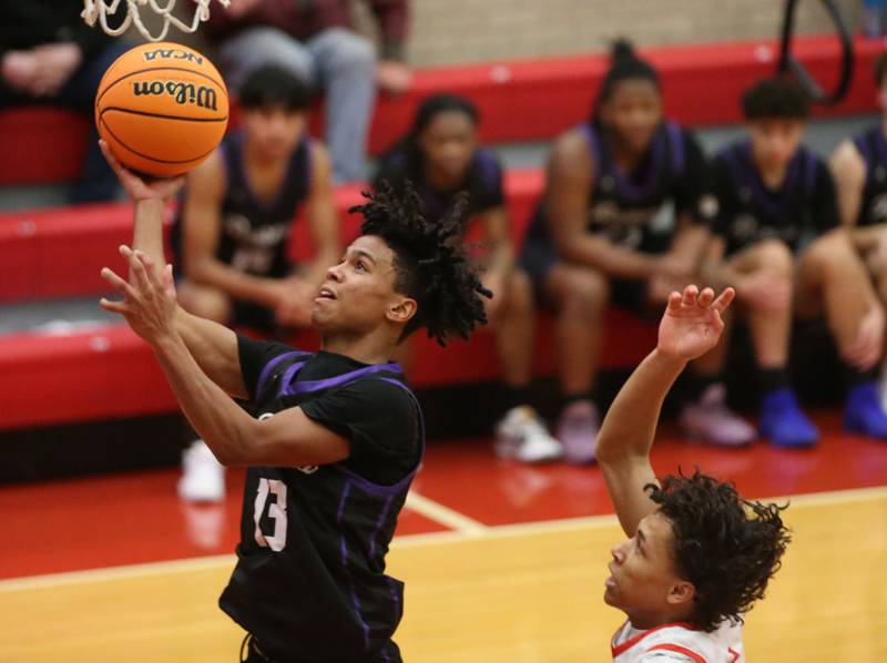 Plano's Amari Bryant eyes the hoop as Ottawa's Hezekiah Joachim defends during the Dean Riley Shootin' The Rock Thanksgiving Tournament on Tuesday, Nov. 26, 2024 in Kingman Gym at Ottawa High School.