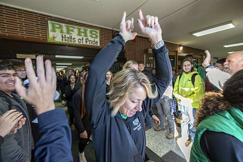 Rock Falls volleyball head coach Sheila Pillars celebrates with the school as she leads her team through the hallway Thursday, Nov. 9, 2023. The team was given a rousing sendoff as they made their way to the state tournament.