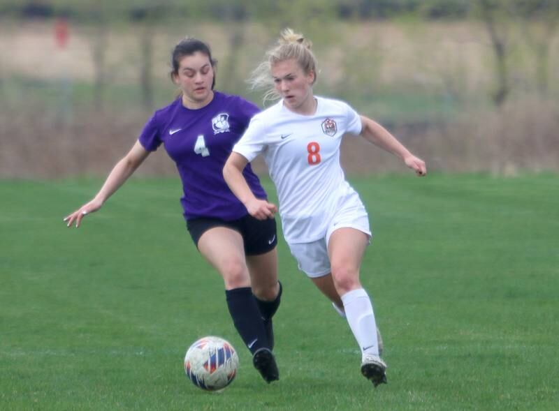 Hampshire’s Adilene Perez, left, battles Crystal Lake Central’s Olivia Anderson, right, in varsity soccer at Hampshire Thursday.