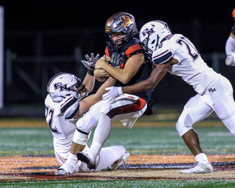 Minooka's Nathan Maul (12) is sacked during football game between Plainfield North at Minooka.   Oct 6, 2023.
