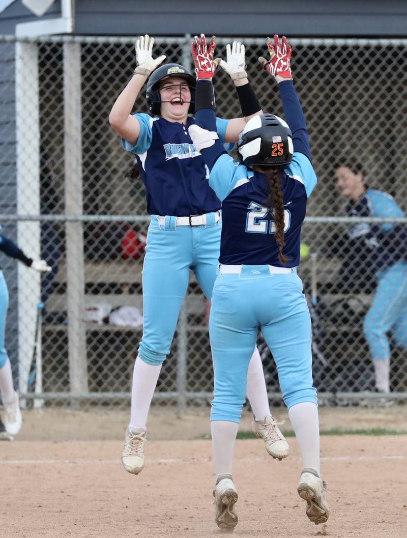 Bureau Valley's Madison Smith gives Tyra Sayler a high five after Sayler's game-winning hit Thursday to lift the Storm to a 14-13 win over rival Princeton in eight innings.