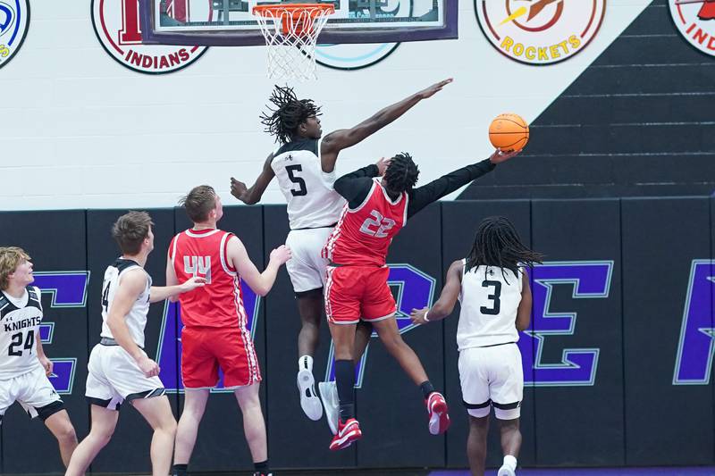 Kaneland's Freddy Hassan (5) defends the paint against Streator's Tristan Finley (22) during a semi-final basketball game in the 61st annual Plano Christmas Classic at Plano High School on Friday, December 27, 2024.
