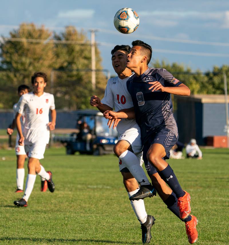 Oswego East's Dupablo Parodis-Yu (9) plays the ball on a header against Oswego’s Killyan Avila (10) during a soccer match at Oswego East High School on Monday, Sep 26, 2022.