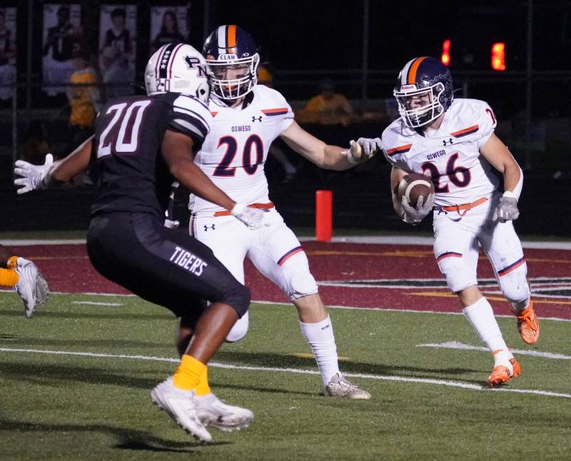 Oswego’s Noah Vera (26) carries the ball against Plainfield North during a football game at Plainfield North High School on Friday, Sept. 22, 2023.