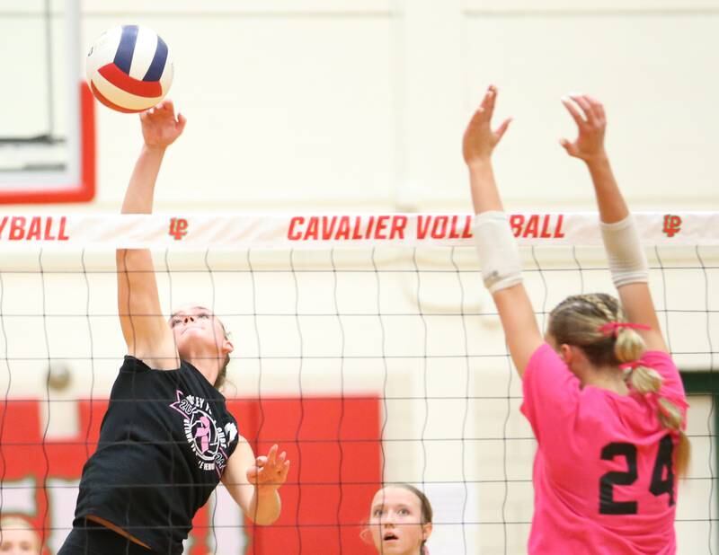 Ottawa's Bell Markey sends a kill past L-P's Aubrey Duttlinger during Volley for a Cure night on Tuesday, Oct. 1, 2024 at AJ Sellett Gymnasium.