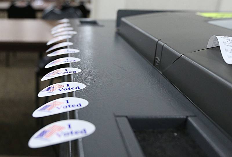 "I Voted" stickers rest on a ballot machine at the Knights of Columbus Hall on Tuesday, Nov. 8, 2022 in Ottawa.