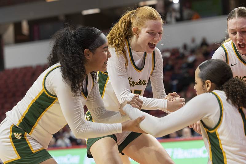 Waubonsie Valley’s Arianna Garcia is helped off the floor by teammates after taking a charge against Nazareth Academy Friday, March 1, 2024 in the girls basketball 4A state semifinal at CEFCU Arena in Normal.