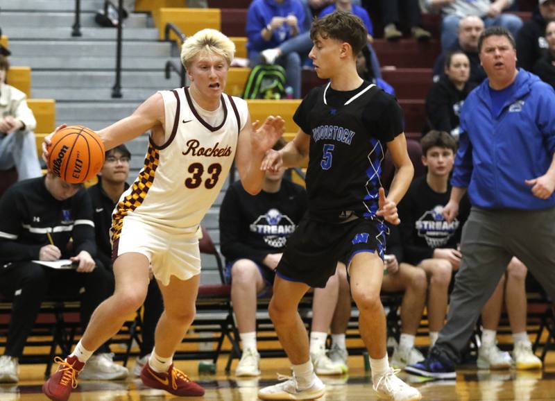 Richmond-Burton's Luke Robinson drives the baseline against Woodstock's Max Beard during a Kishwaukee River Conference boys basketball game on Friay Jan. 9  2026, at Richmond-Burton High School, in Richmond.