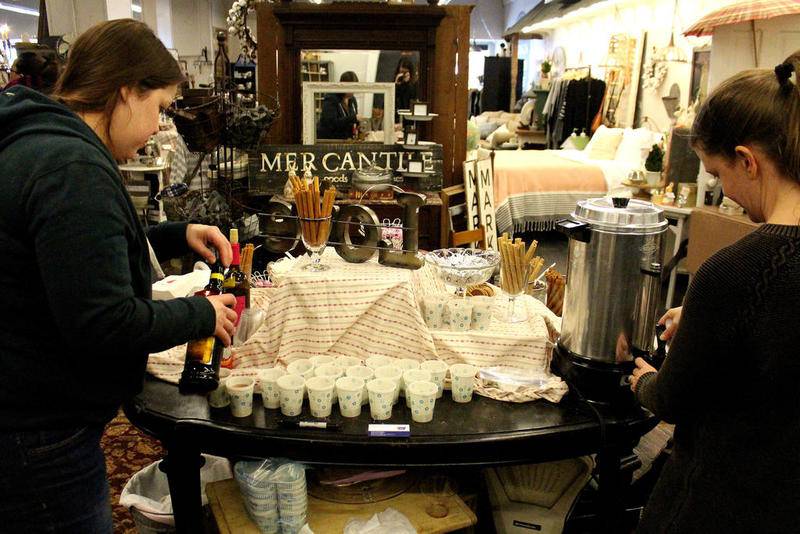 Autumn Narney (left) and Amy Haines (right) ran the hot chocolate bar at the Hudson Design House in downtown Oswego as the store's contribution to the annual Chocolate Walk for Charity. Participants could choose from a variety of ingredients, including whipped cream, chocolate chips and Kahlua.